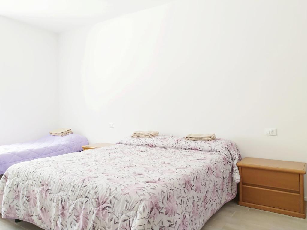 Ένα ή περισσότερα κρεβάτια σε δωμάτιο στο Levico Al Corso Apartments