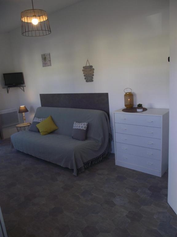 a bedroom with a bed and a dresser at Pétale de RoZ au pied du Mont Saint Michel in Roz-sur-Couesnon