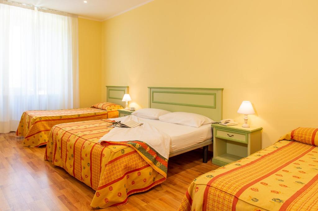 Postel nebo postele na pokoji v ubytování Hotel Minerva