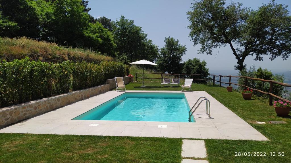 a swimming pool in the middle of a yard at Podere Calistri in Larciano