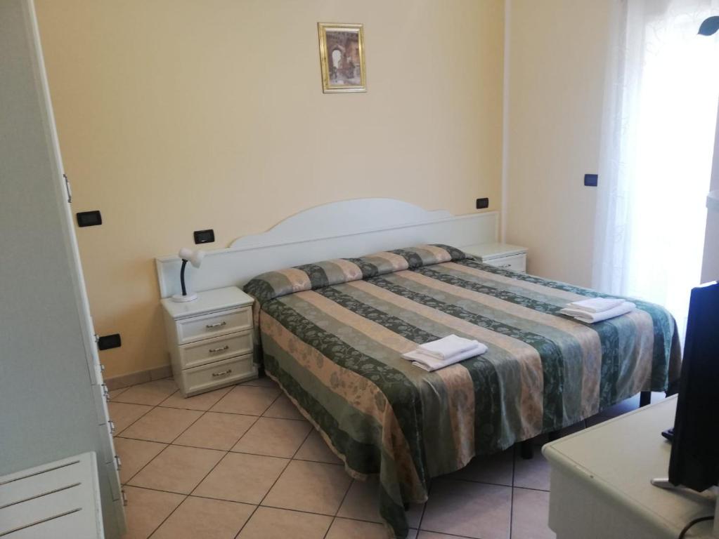 Łóżko lub łóżka w pokoju w obiekcie Hotel Grazia Ristorante