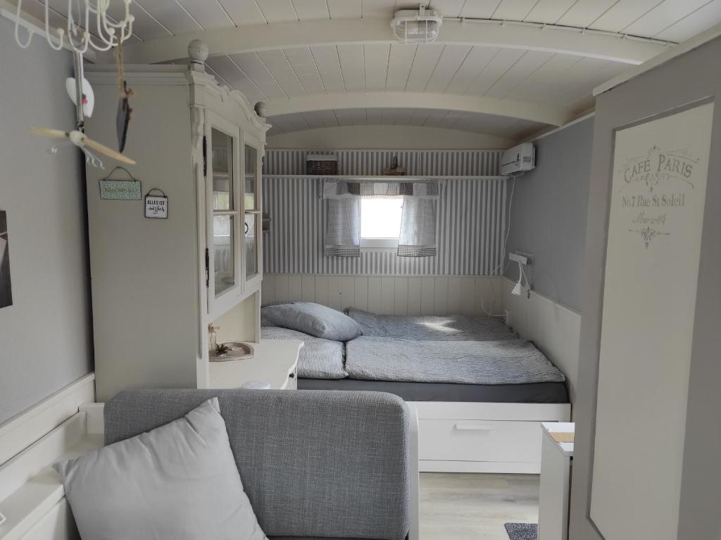 a small bedroom with a bed and a couch at Zum Scheunenhof - Scheune in Ichenhausen