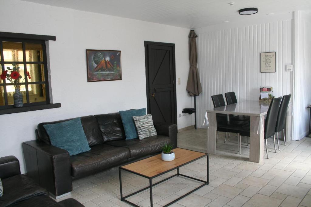 a living room with a couch and a table at Vakantiehuis Martien in Peer