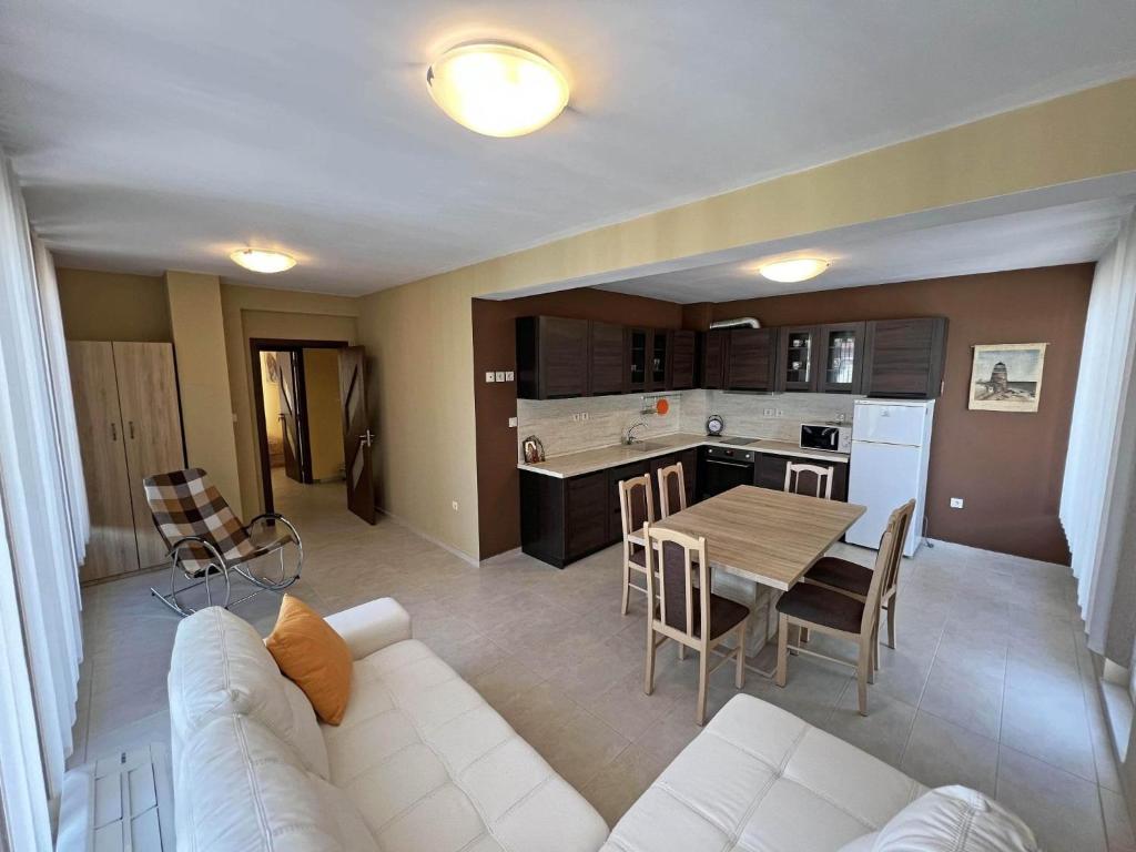 a living room with a white couch and a table at Valemar Apartments in Pomorie