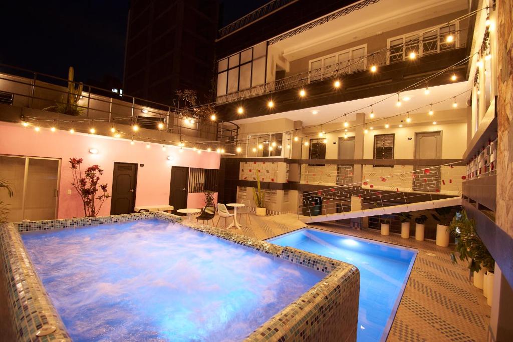 a large swimming pool in the middle of a building at HOTEL BRANA in Medellín