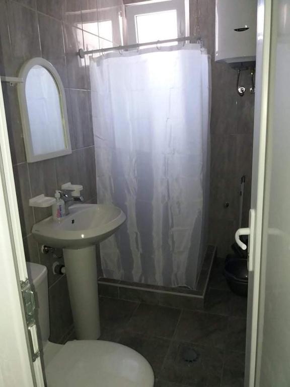 a bathroom with a sink and a shower curtain at Apartment’s Maric - Zelenika,Herceg Novi in Zelenika