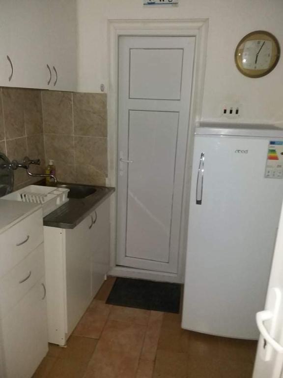 a kitchen with a white door and a refrigerator at Apartment’s Maric - Zelenika,Herceg Novi in Zelenika