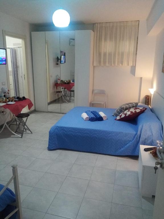 a bedroom with a bed with a blue comforter at Casa di Ale in Diamante