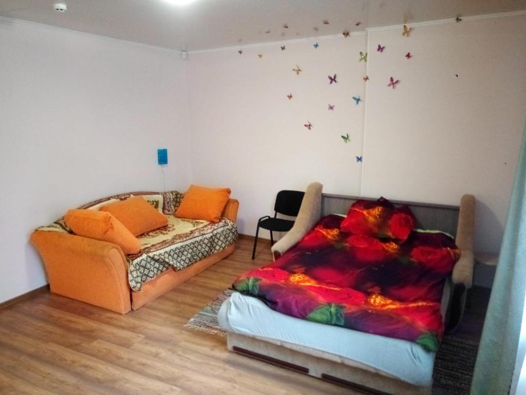 salon z łóżkiem i kanapą w obiekcie Viestura apartamenti w mieście Dyneburg