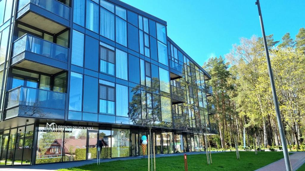 an office building with a glass facade at Park Premium Apartments in Birštonas