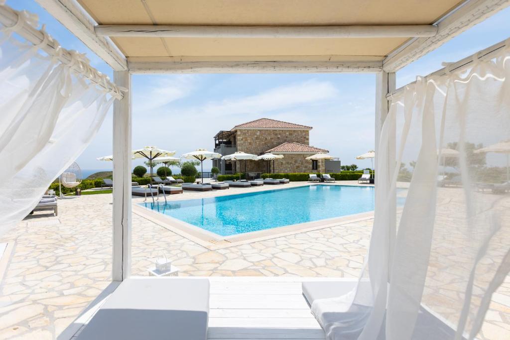a view of the pool from the patio of a villa at Tramonto Suites in Xi