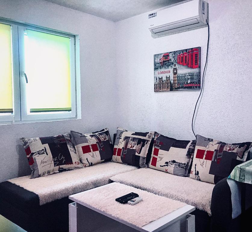 a living room with a couch with pillows at Renata Holiday Apartments in Ulcinj