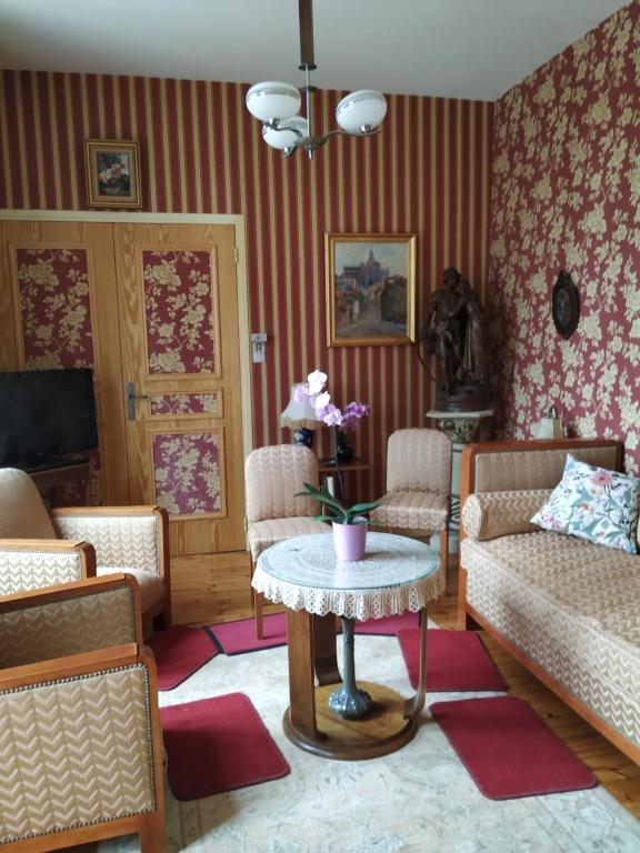a living room with a table and chairs at La Maison de Mireille in Le Puy-en-Velay