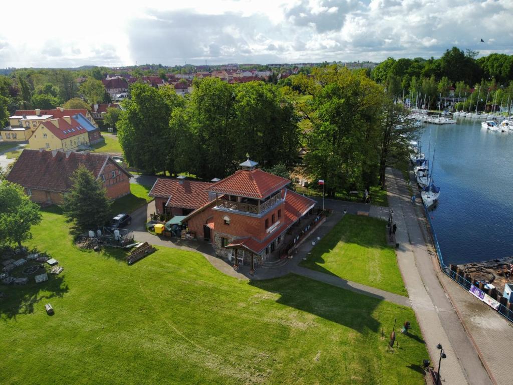 an aerial view of a large house on the water at Ekomarina - Pokój noclegowy 1 in Węgorzewo