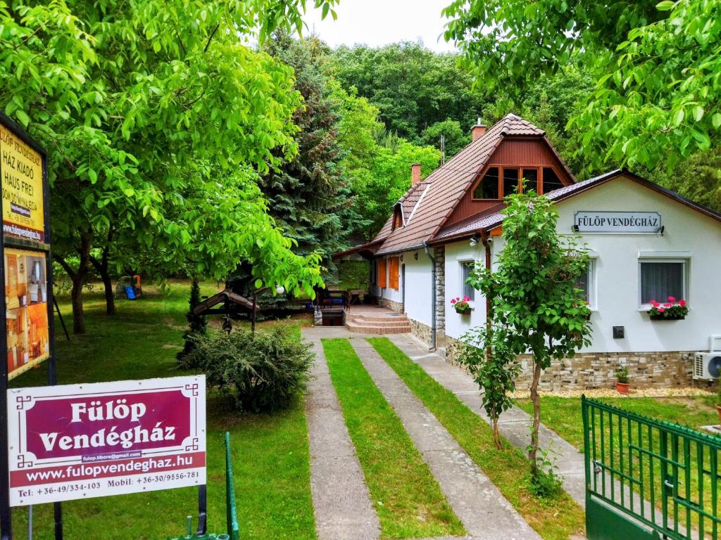 a house with a sign in front of it at Fülöp Vendégház in Bogács