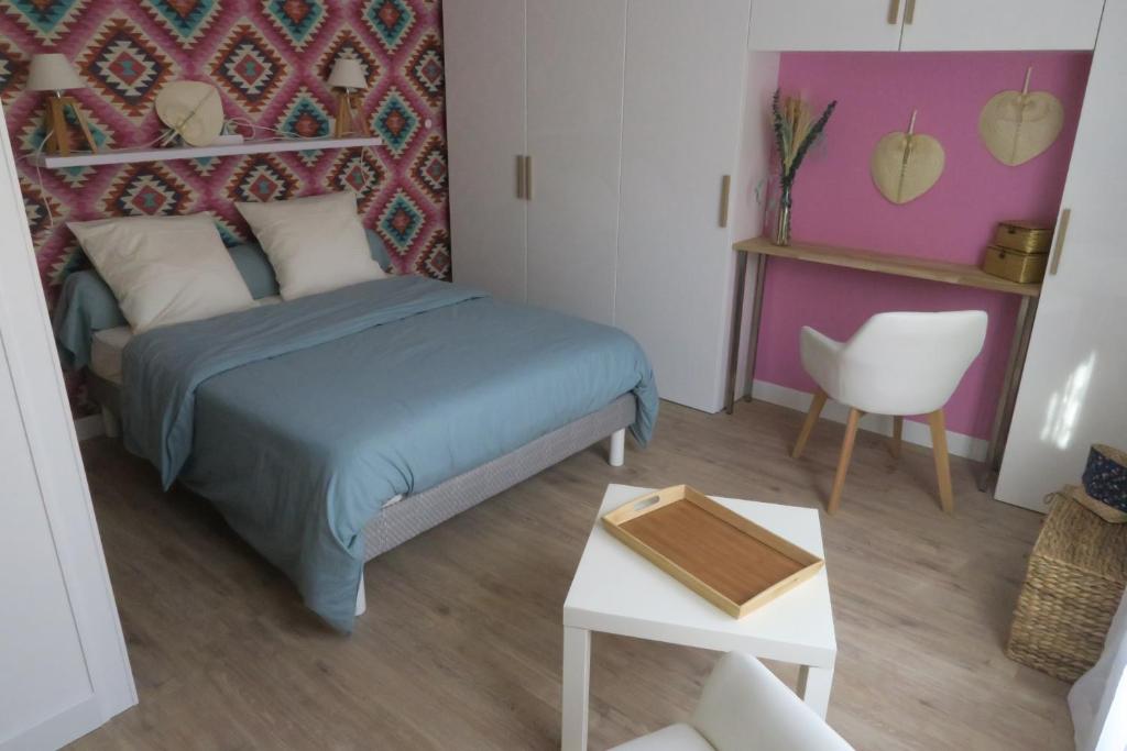 Vagabondes chambres d'hôtes في آزاي-لو-ريدو: غرفة نوم صغيرة مع سرير وطاولة
