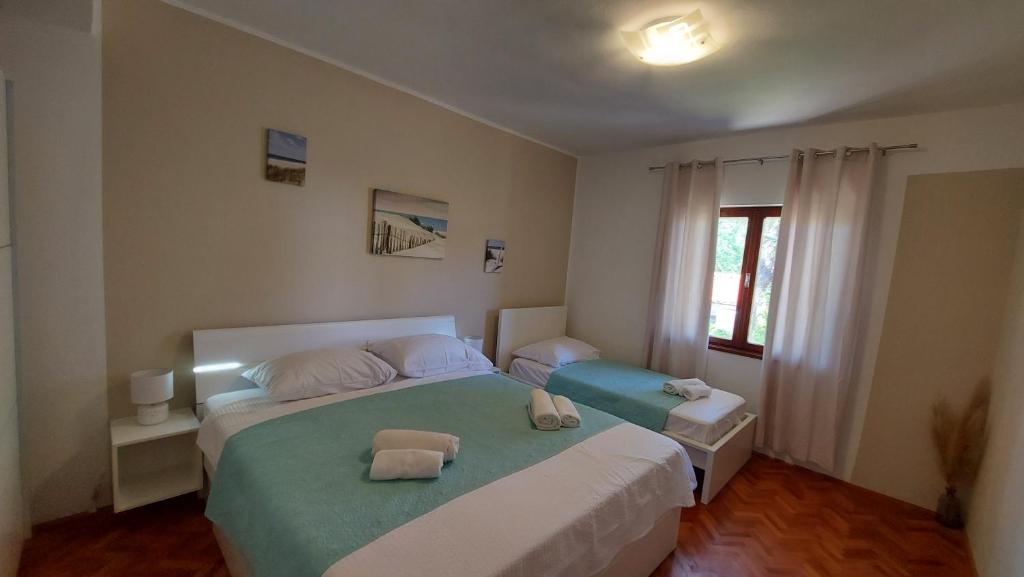 Posteľ alebo postele v izbe v ubytovaní Kuća Magnolija
