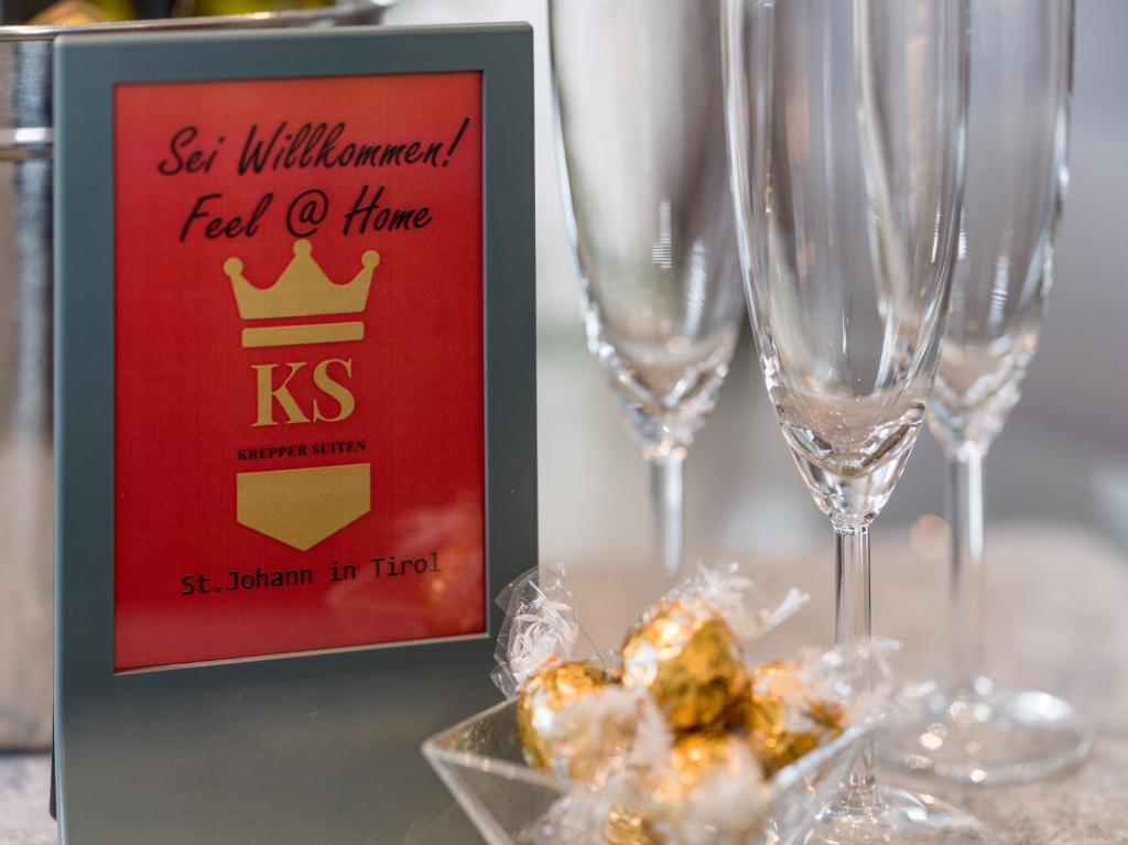 a picture of a sign with champagne glasses on a table at KS - Suiten in Sankt Johann in Tirol