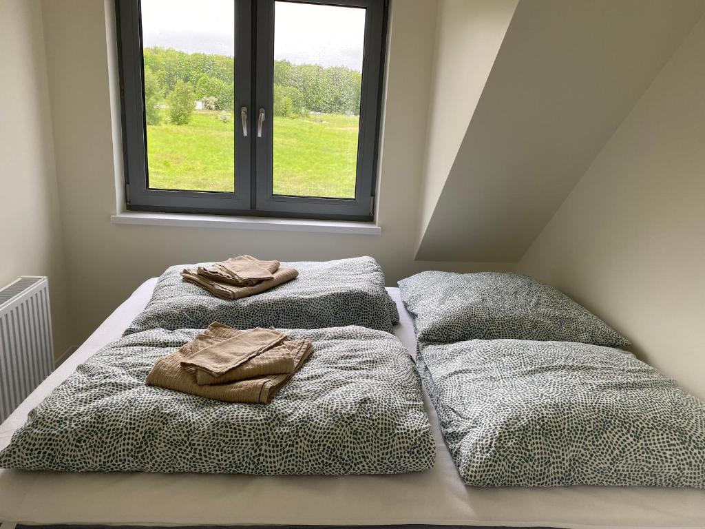 Cama ou camas em um quarto em Casa Milo - Trzęsacz