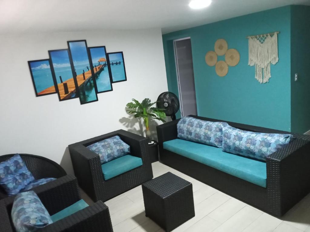 a living room with two couches and two chairs at Apartamento Praia Enseada Guarujá Wilma - próximo da praia - com ar condicionado e vaga para carro in Guarujá