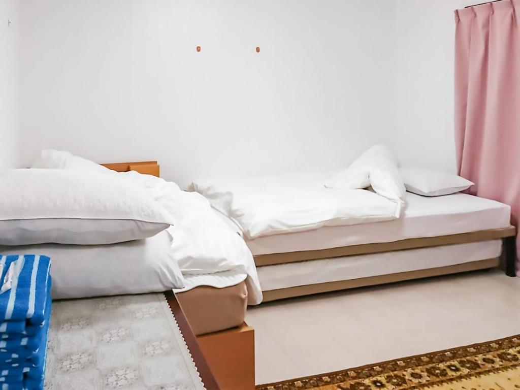 Postel nebo postele na pokoji v ubytování Oyama Guesthouse Kyoto