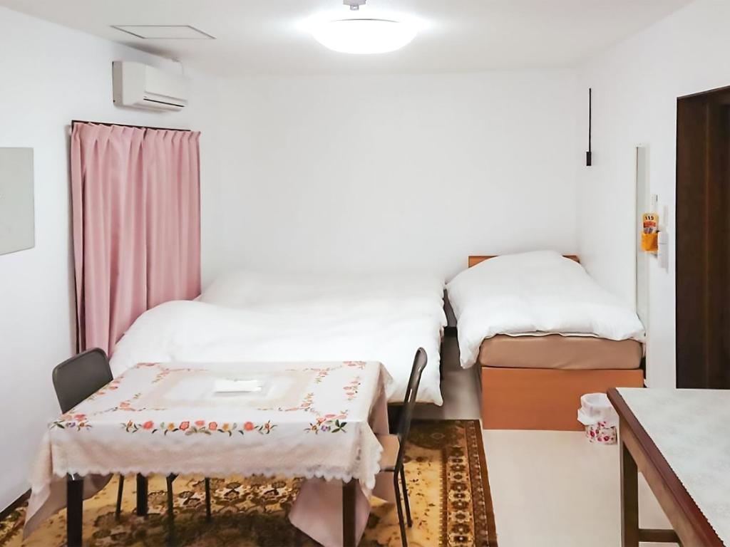Postel nebo postele na pokoji v ubytování Oyama Guesthouse Kyoto