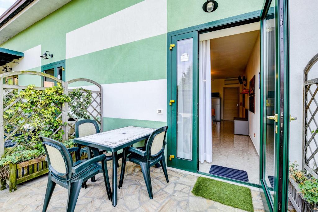stół i krzesła na patio domu w obiekcie La Forgia Apartments w mieście Peschiera del Garda