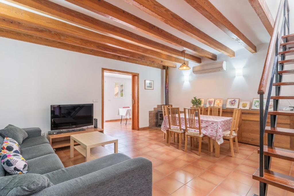 a living room with a couch and a table at Cas Pobres in Sóller