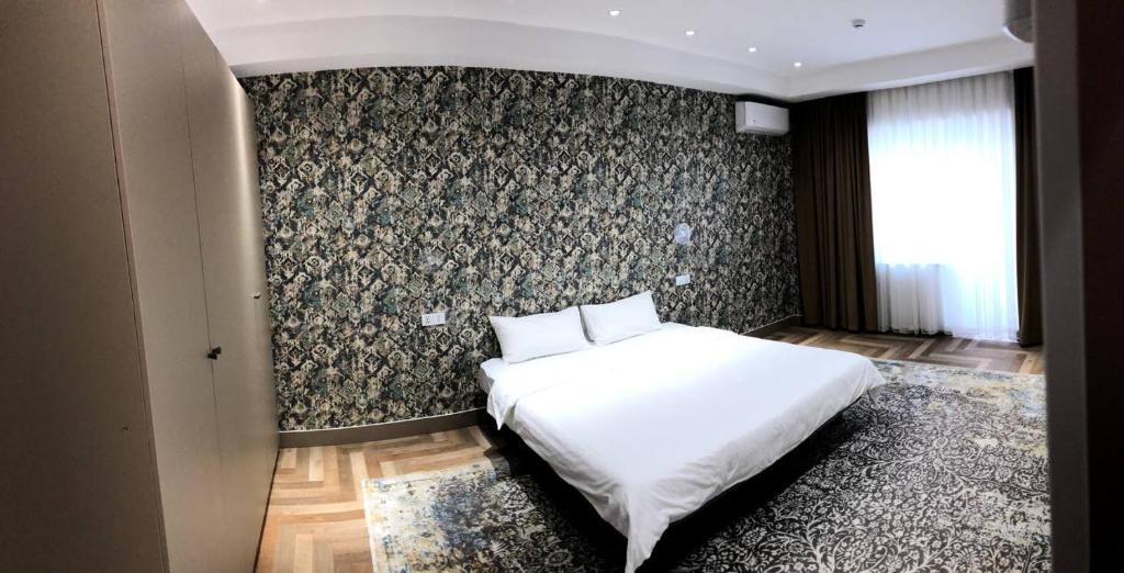מיטה או מיטות בחדר ב-Tashkent City View Apart