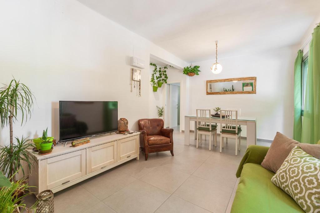 a living room with a flat screen tv and a couch at Boutique Beach Mataró in Mataró