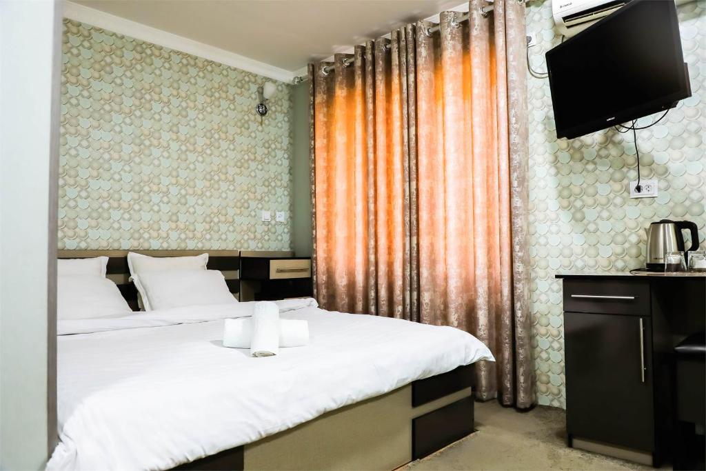 מיטה או מיטות בחדר ב-Reikartz Kokand