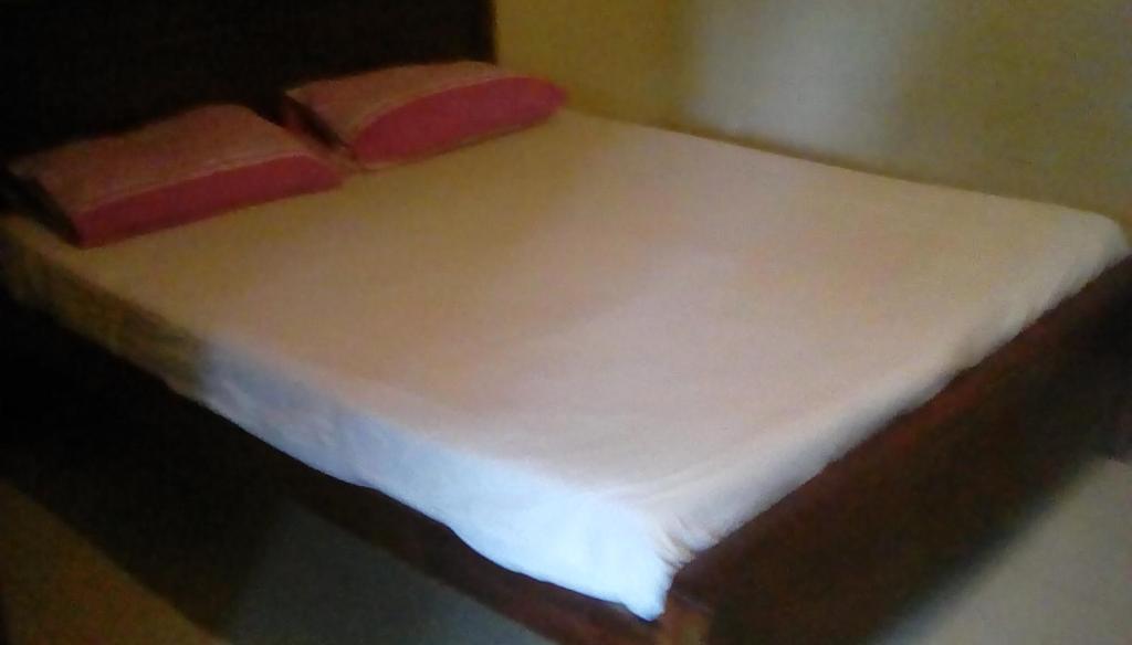Postel nebo postele na pokoji v ubytování Leaf Guest House