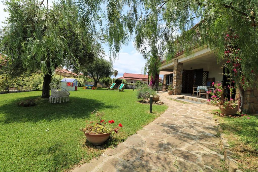 un patio con una casa y algunas flores en Villa di Marinella en Ascea