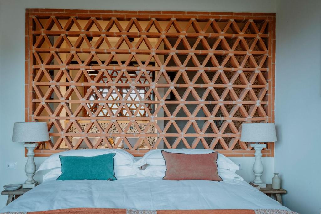 Postel nebo postele na pokoji v ubytování Borgo 69 Villas & Suites