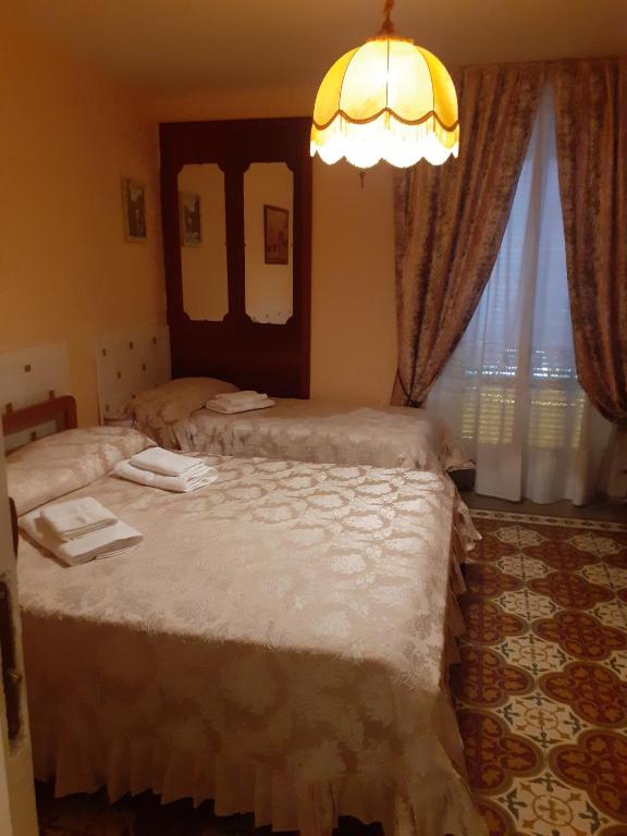 A bed or beds in a room at Affittacamere GERANI