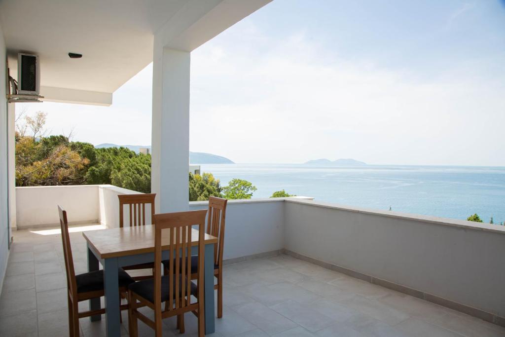 a dining room with a table and chairs and the ocean at Aerial Hotel & Spa in Vlorë