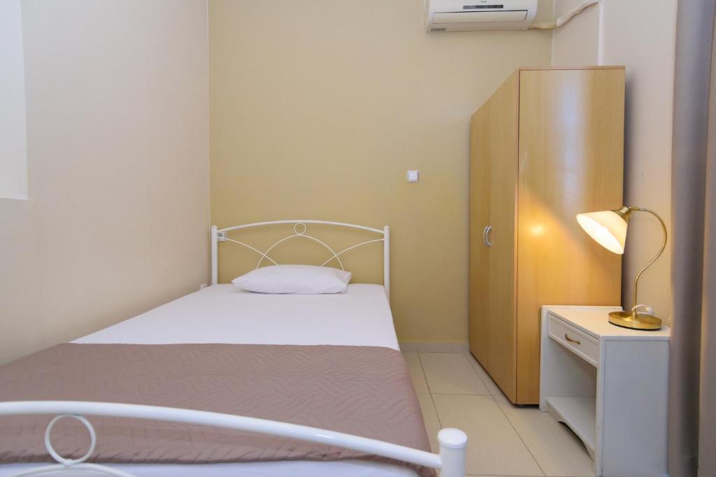 Postel nebo postele na pokoji v ubytování Archontiki City Hotel