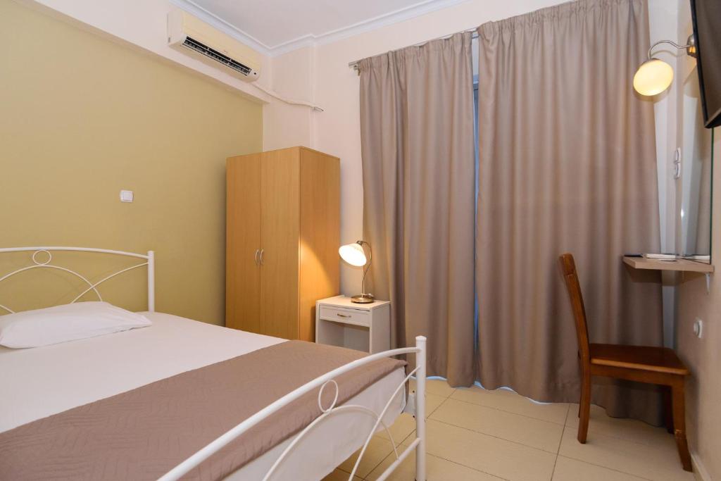 Postel nebo postele na pokoji v ubytování Archontiki City Hotel
