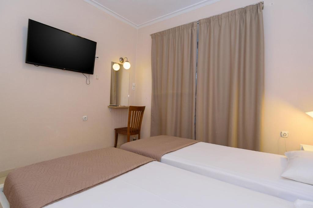 Postel nebo postele na pokoji v ubytování Archontiki City Hotel