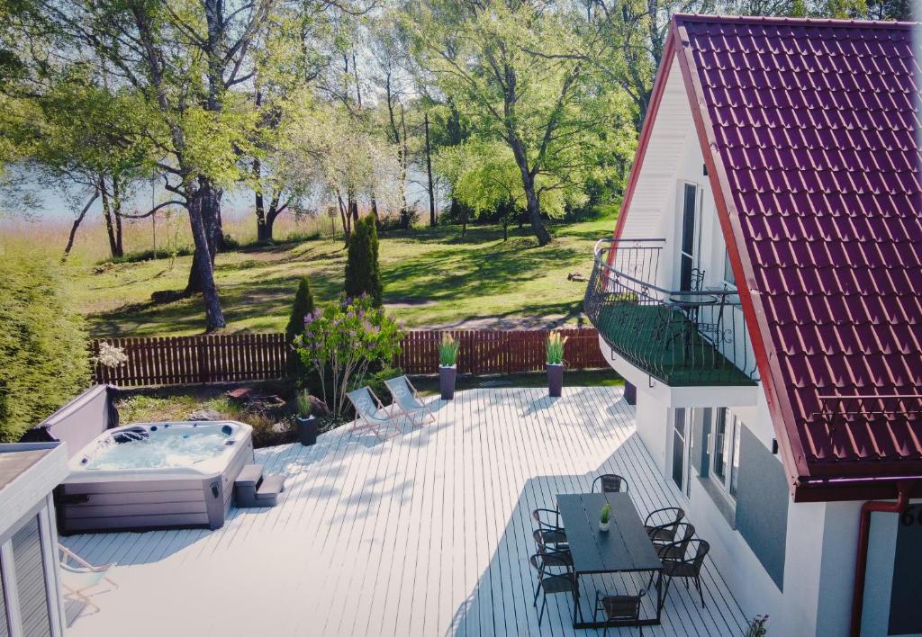 a patio with a hot tub next to a house at Wila Dom Nad Jeziorem Mazury in Sorkwity
