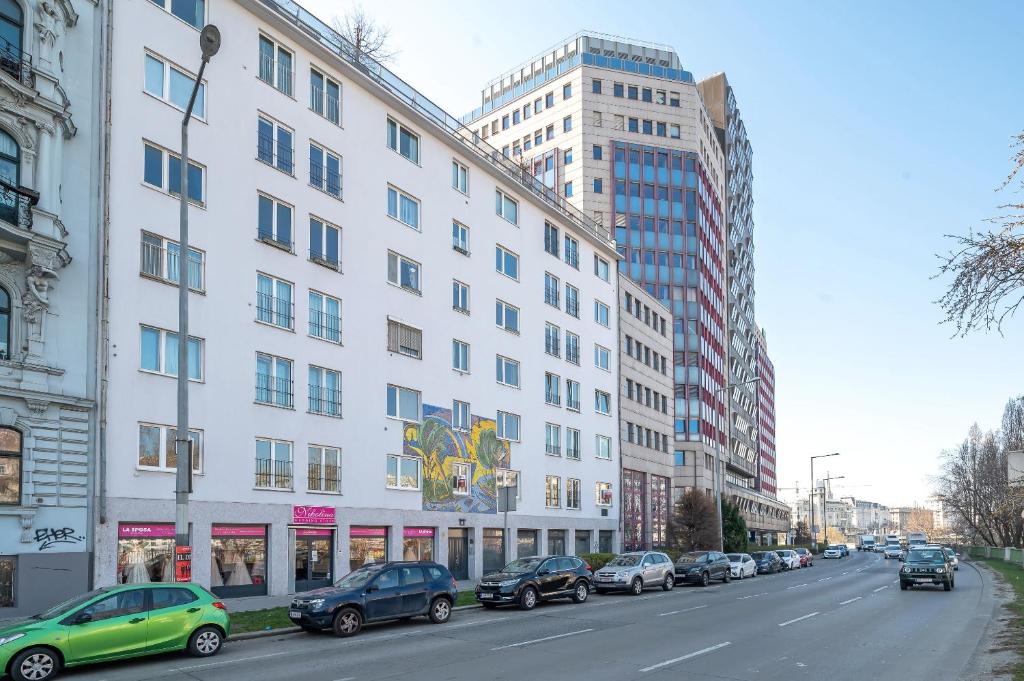 a city street with cars parked in front of buildings at City Center Lofts in Vienna