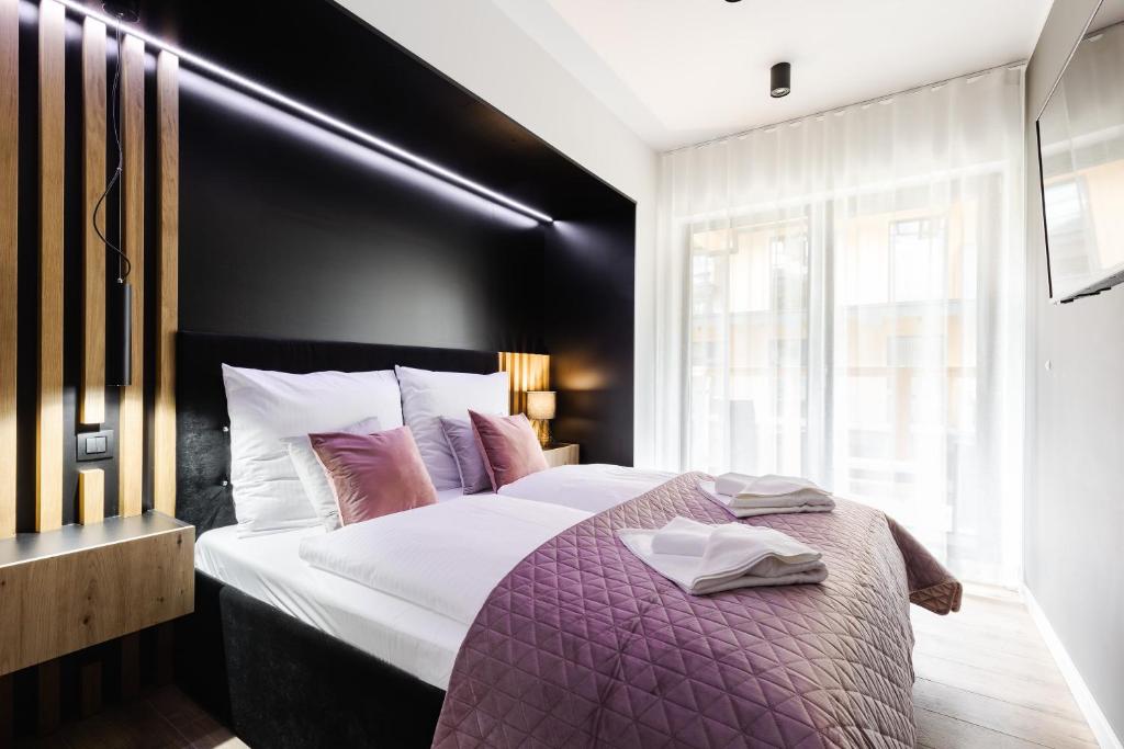 Posteľ alebo postele v izbe v ubytovaní Apartamenty Modrzejewskiej Zakopane