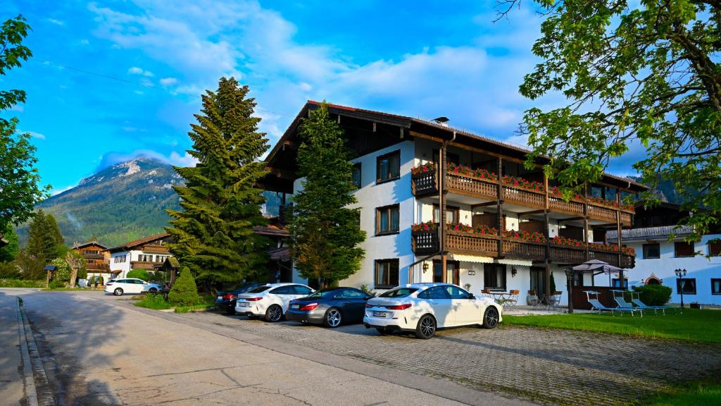 a large building with cars parked in front of it at Hardi's Hotel in Inzell