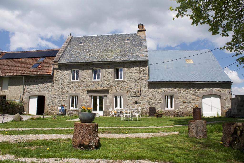 an old stone house with a solar roof at Chez de Vergne in Chanterelle