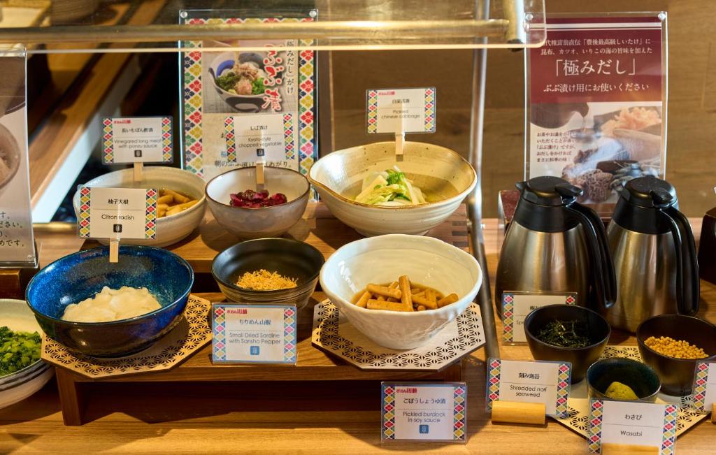 a display of bowls of food on a table at Kyoto Tower Hotel in Kyoto