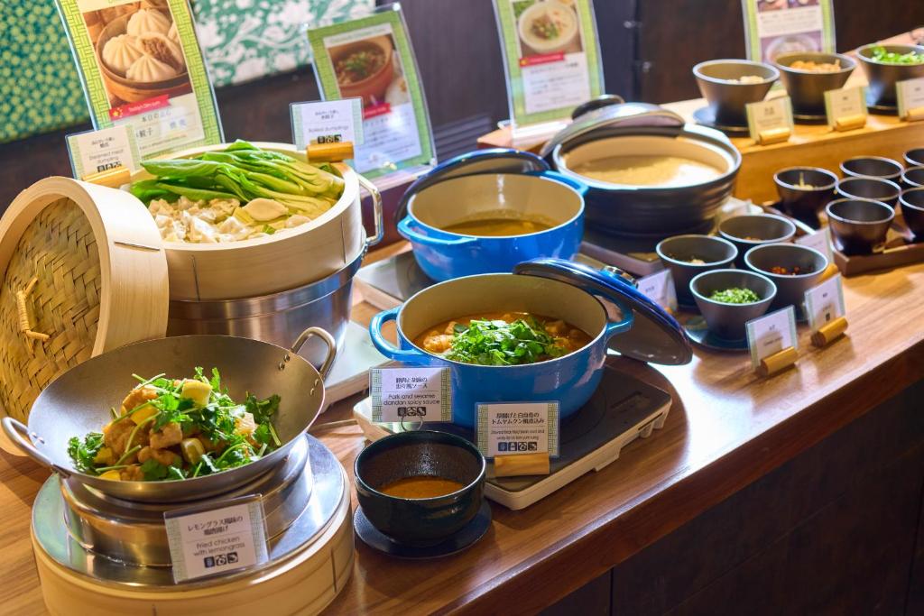 a buffet with bowls of food on a table at Kyoto Tower Hotel in Kyoto
