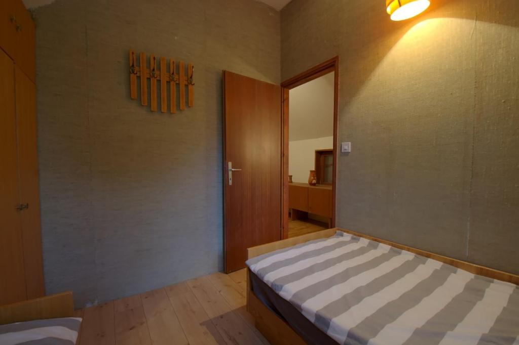 a bedroom with a bed and a door to a room at kuća za odmor Anić in Pirovac