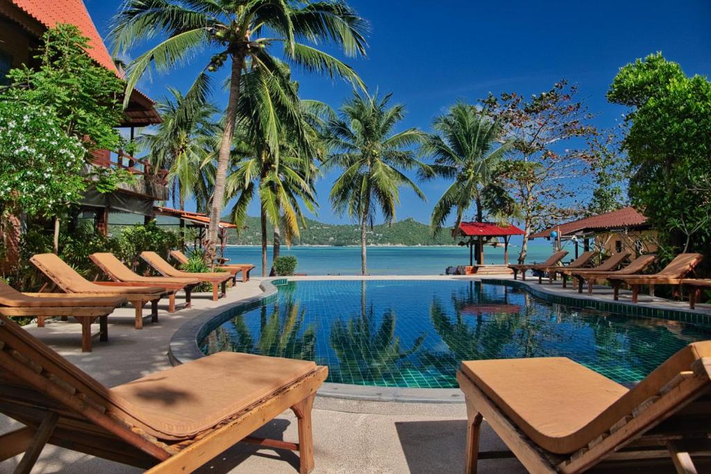 a swimming pool with lounge chairs and a resort at Longtail Beach Resort in Thong Nai Pan Yai