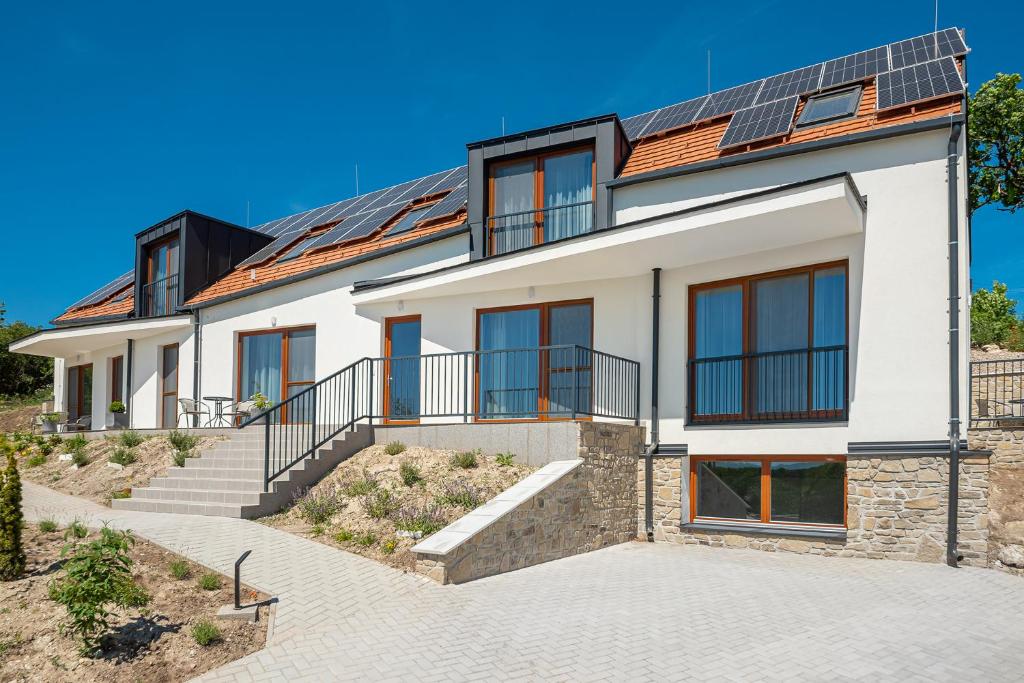 a house with solar panels on the roof at Hérics Apartman in Tihany