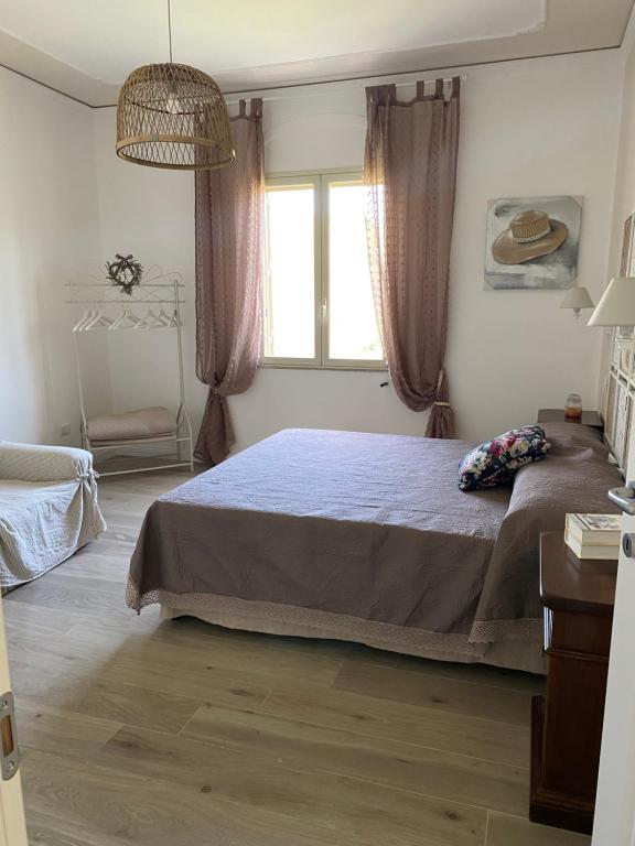A bed or beds in a room at Tra mare e lago
